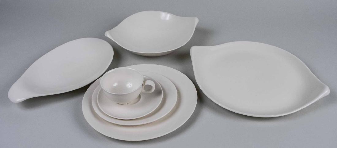 Eva Zeisel for Crate & Barrel: Made in England for Royal Stafford, comprising twelve dinner plate, twelve salad plates, twelve cups and saucers and six serving dishes. Dinner plate, diameter 11 inches. Notice to bidders: Condition