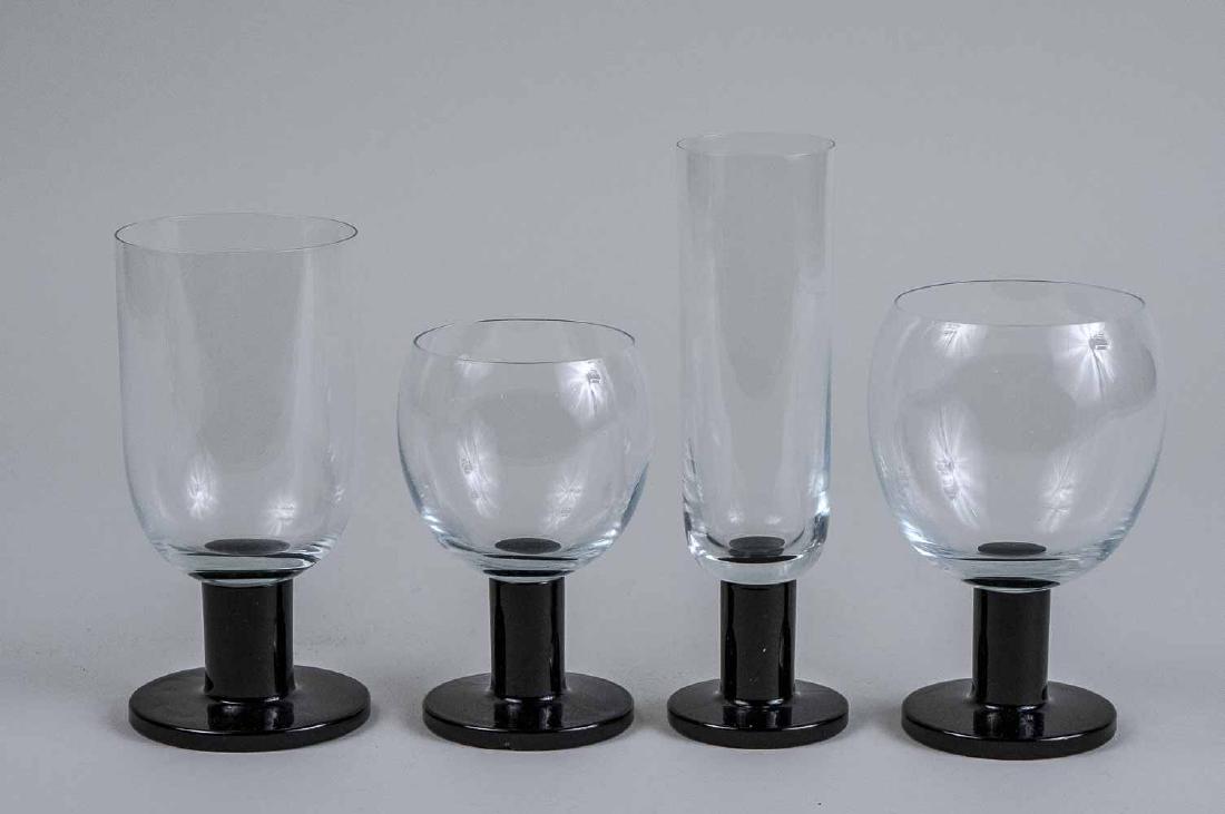 Stemware Set: Approximately fifty one pieces, colorless glass bowls with black glass stems, comprising twenty eight champagne flutes, twelve red wine glasses, eight white wine glasses, and three water goblets. Cham