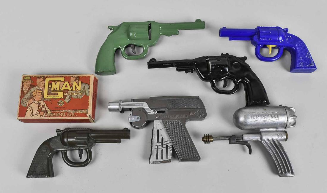 Group of Vintage Toy Guns: Seven pieces, metal and plastic examples, including a Atom Ray Gun (non-working), a G-Man Automatic pistol (in original box), etc. Notice to bidders: Condition reports and additional photographs are p