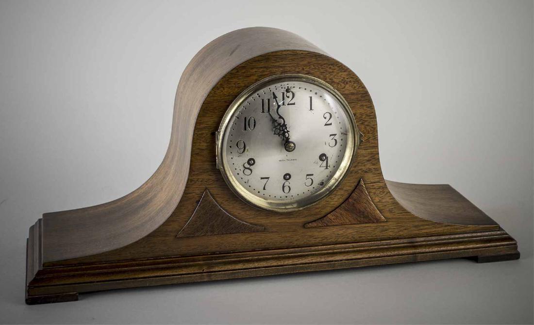 Seth Thomas Mahogany Mantel Clock: Arched top case, dial with Arabic numerals. Height 8 inches. Notice to bidders: Condition reports and additional photographs are provided by request as a courtesy to our clients, as such any condition