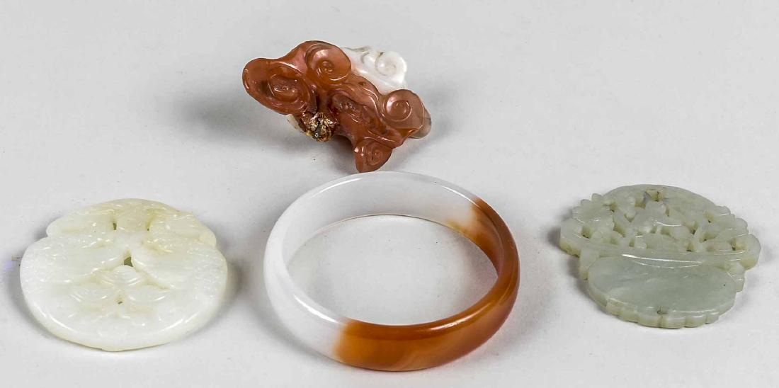 Group of Carved Carnelian and Jade Articles: Bangle and three pendants. Notice to bidders: Condition reports and additional photographs are provided by request as a courtesy to our clients, as such any condition report is only an opinion and sho