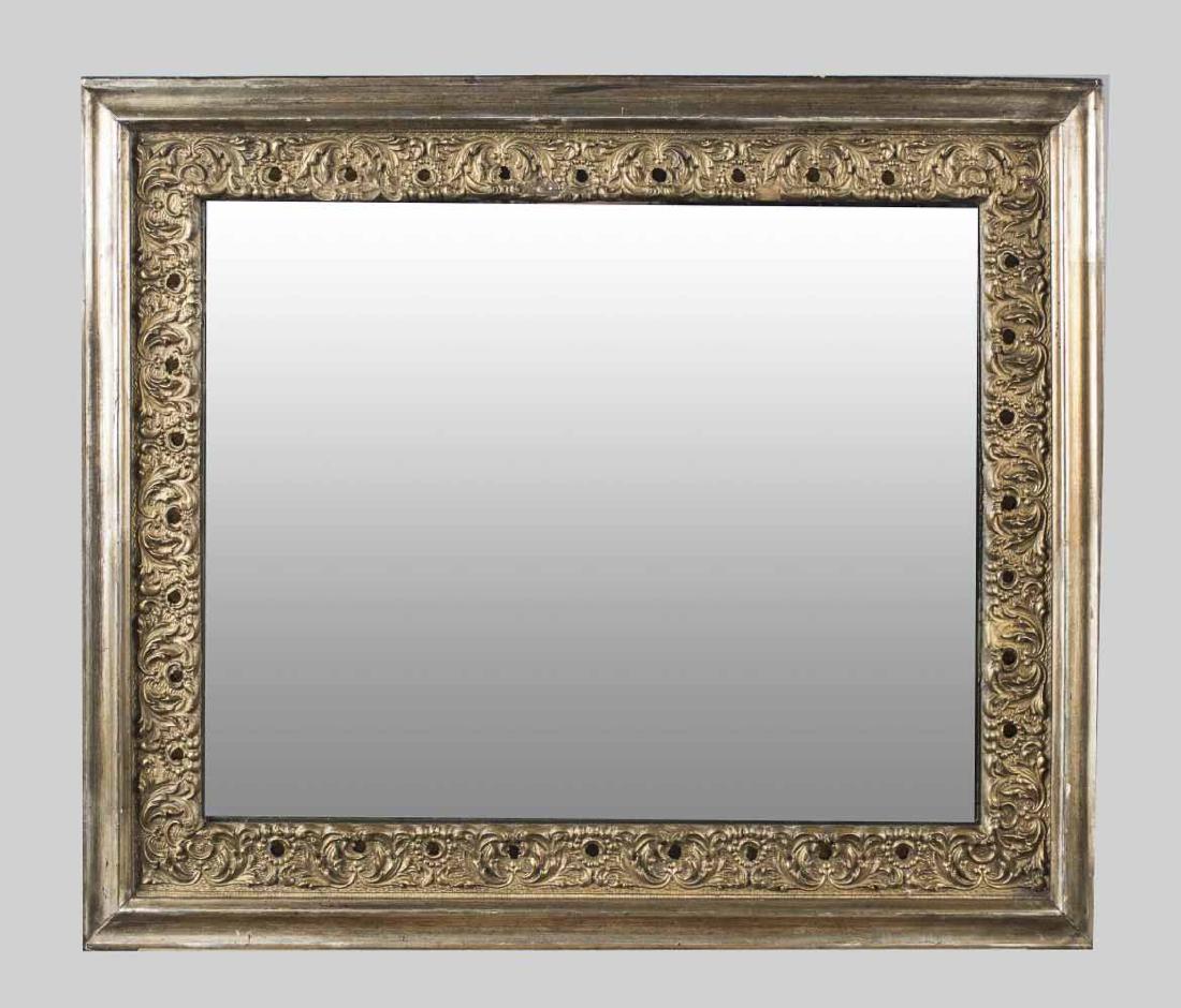 Gilt Wood Mirror: Leafy scroll border. Height 22 inches, width 26 inches. Notice to bidders: Condition reports and additional photographs are provided by request as a courtesy to our clients, as such any condition repo
