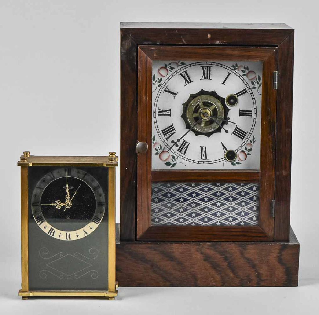 Two Vintage Clocks: An Ansonia rosewood case shelf clockk with time and striking on a bell and a Jaeger brass boudoir clock. Ansonia, height 9 1/2 inches. Notice to bidders: Condition reports and additional photographs a