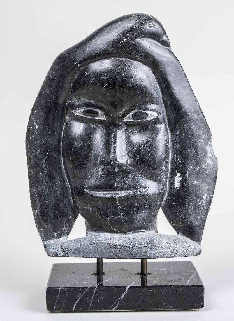 Inuit Carved Stone Sculpture: Face with bird form on head. Illegible signature and dated 1960s on base. Mounted with brass rods to marble base. Overall height, 10 inches. Length, 7 inches. Notice to bidders: Condition reports and 