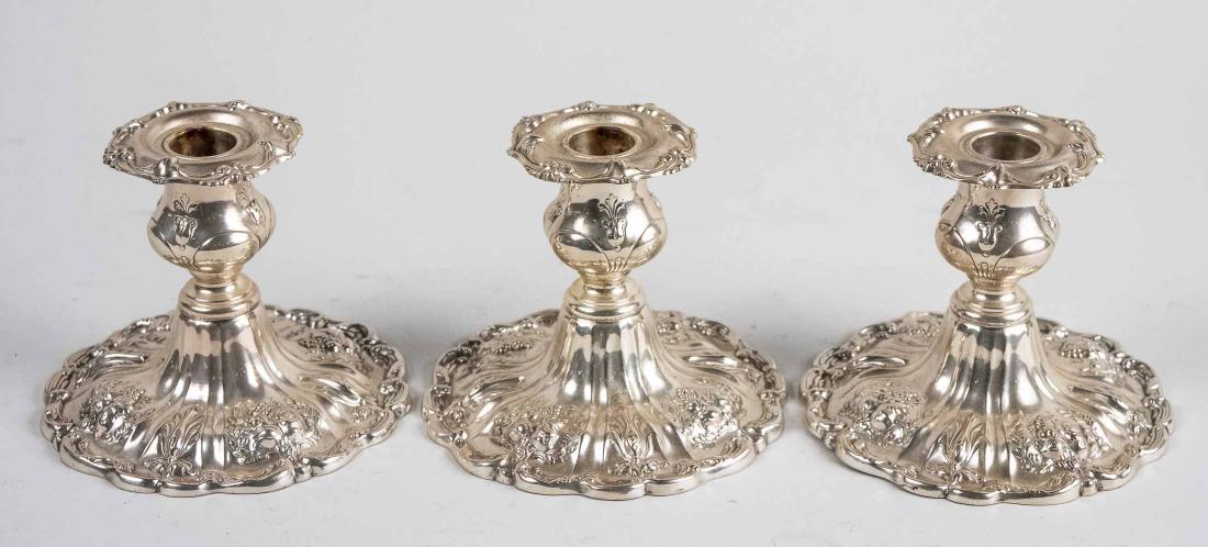 Set of Three Reed and Barton Silver Candlesticks: Francis I pattern. Height 4 1/8 inches, weighted. Notice to bidders: Condition reports and additional photographs are provided by request as a courtesy to our clients, as such any condition report is