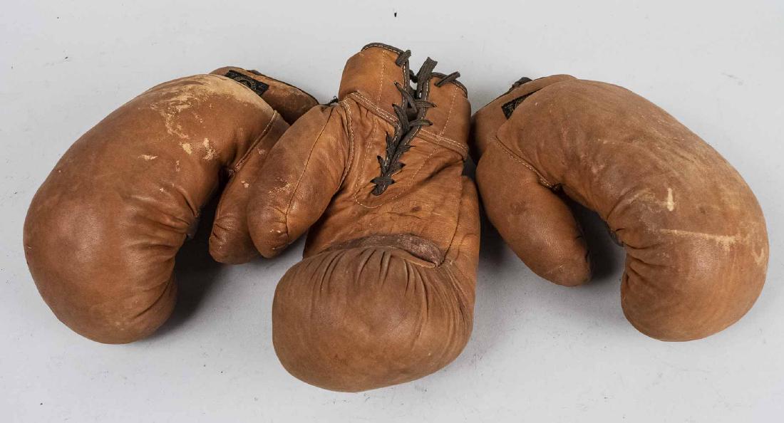 Three Vintage Leather Boxing Gloves: Alex Taylor & Co., New York, label on all three ( two right hand gloves and one left hand glove.. Notice to bidders: Condition reports and additional photographs are provided by request as a courtesy 