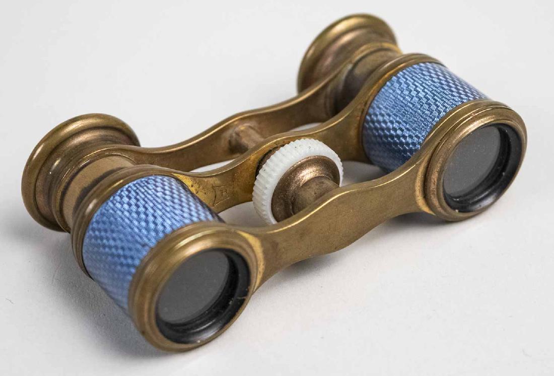 Pair of French Guilloche Enamel Opera Glasses: Blue guilloche enamel decoration. Width 3 3/8 inches. Notice to bidders: Condition reports and additional photographs are provided by request as a courtesy to our clients, as such any condition report