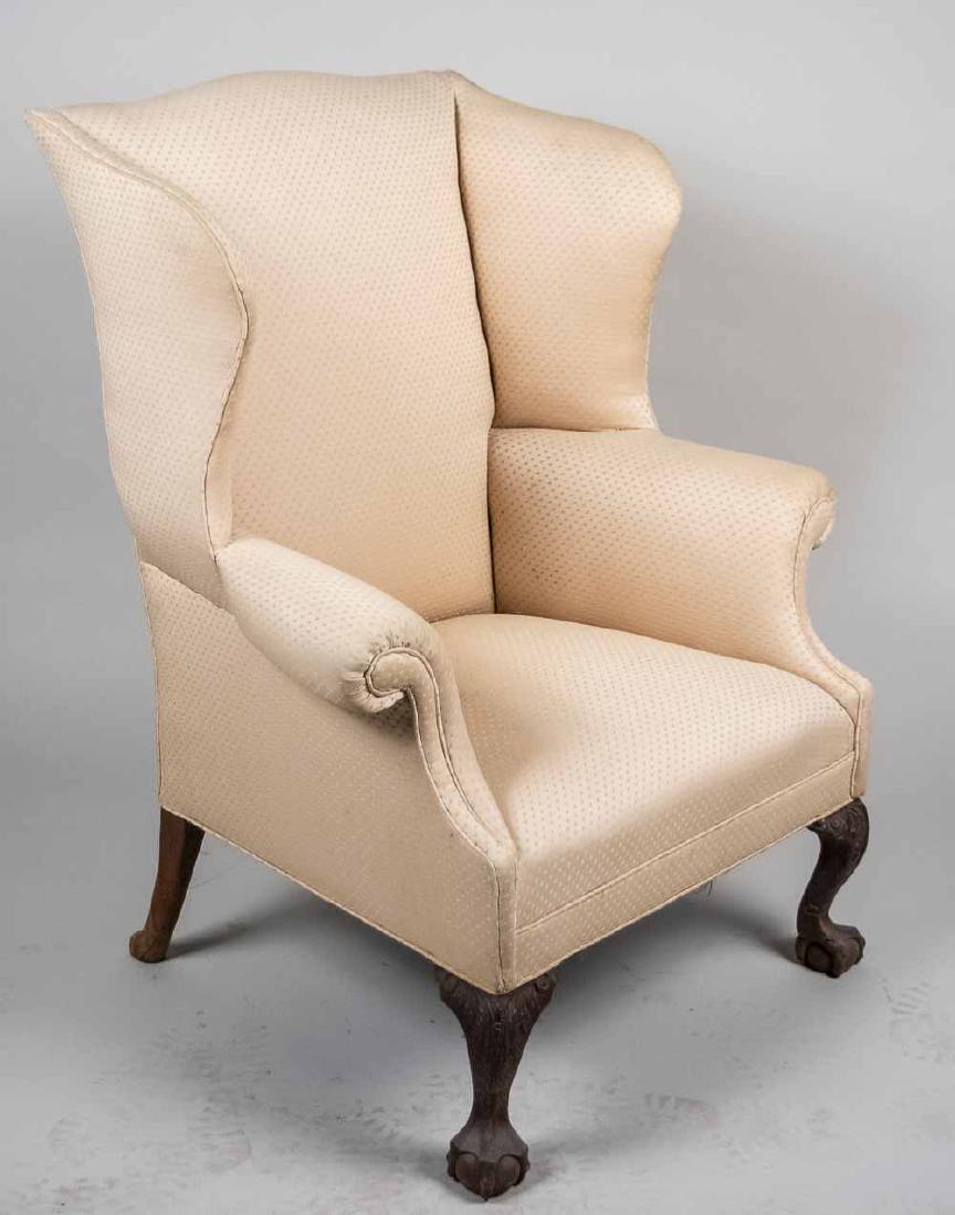 Chippendale Wing Chair: Cream upholstered chair, cabriole legs ending in claw and ball feet. Height 45 1/2 inches, width 36 inches, depth 31 inches. Notice to bidders: Condition reports and additional photographs are provide