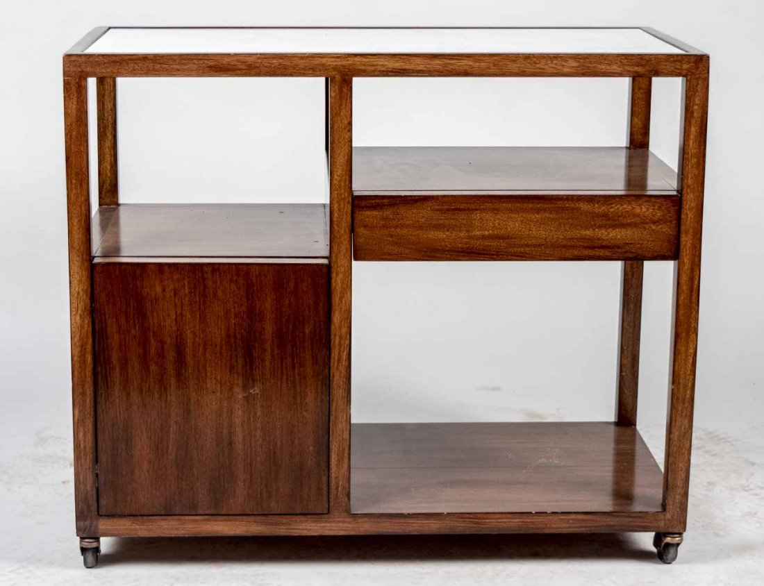 Harvey Probber Tea Cart: Rectangular top with faux marble inlay, over a bank of open shelves, a single door cabinet, and a single short drawer, on casters. Height 32 inches, width 38 inches, depth 18 inches.
