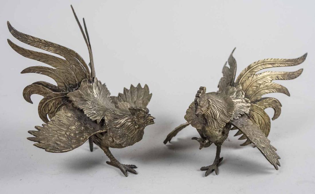 Pair of Brass Cockerels: Modeled in a combative posture. Taller, height 4 1/4 inches. Notice to bidders: Condition reports and additional photographs are provided by request as a courtesy to our clients, as such any condition