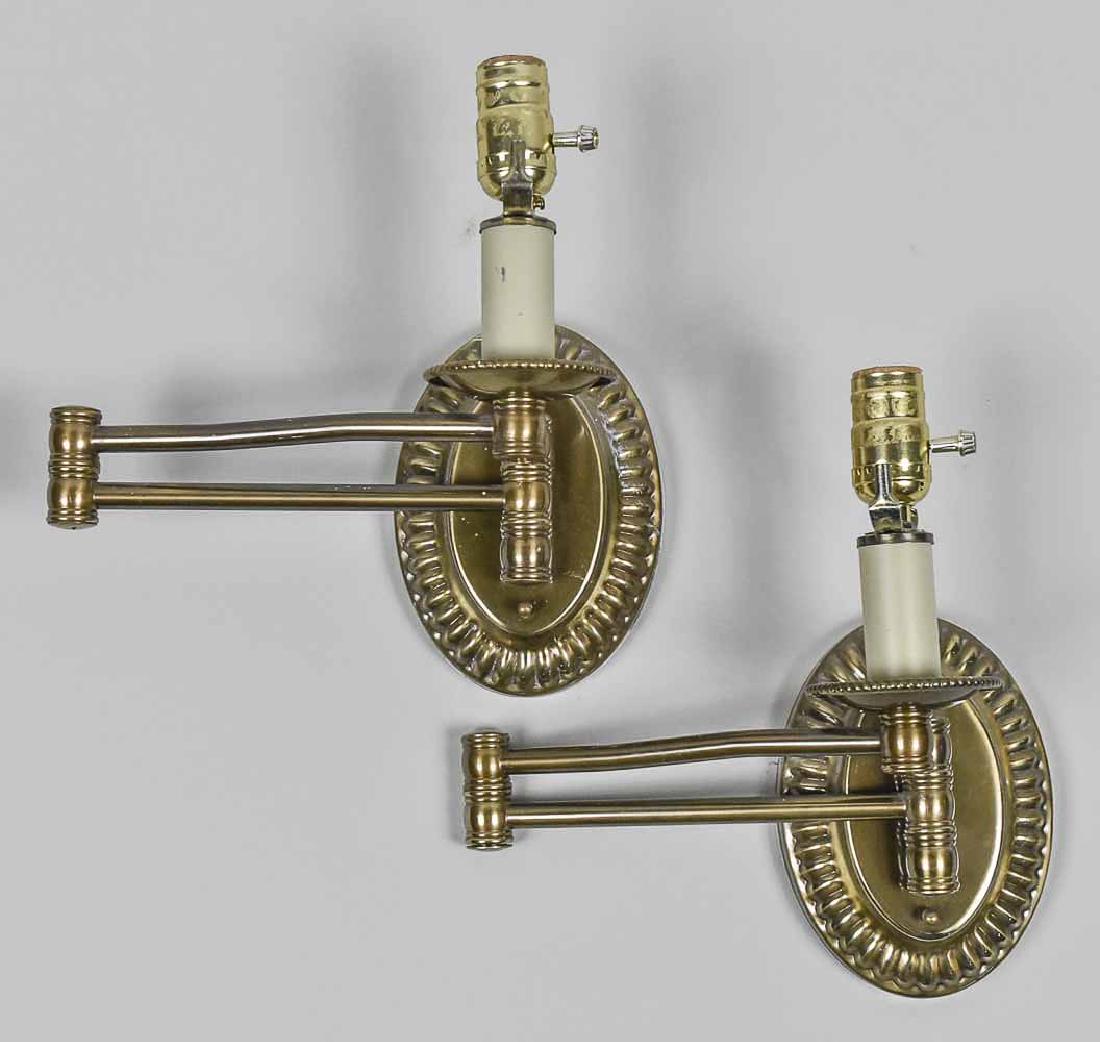 Pair of Sconces: Single light candlestick sconces with adjustable arms, oval backplate. Height 8 inches. Notice to bidders: Condition reports and additional photographs are provided by request as a courtesy to our cli