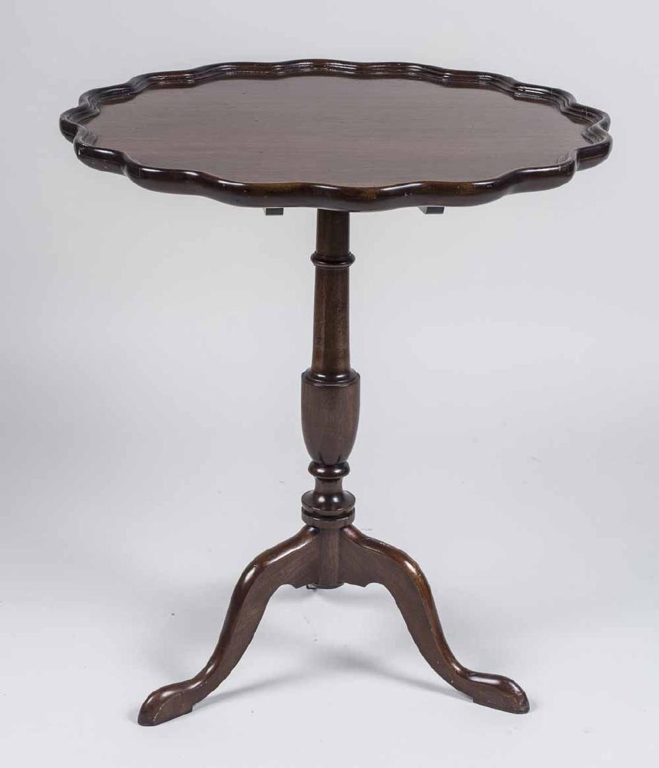 Pie Crust Table: Circular top on a tripod base. Height 29 inches, diameter 26 inches. Notice to bidders: Condition reports and additional photographs are provided by request as a courtesy to our clients, as such any c
