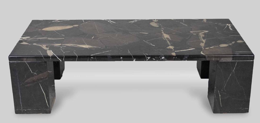 Black Marble Coffee Table: Rectangular top on block legs. Height 14 inches, width 52 inches, depth 26 inches. Notice to bidders: Condition reports and additional photographs are provided by request as a courtesy to our clients,