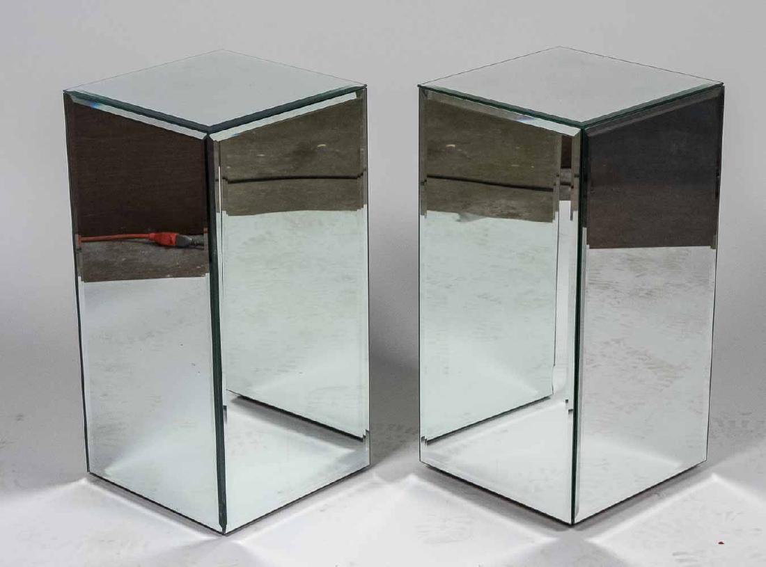 Pair of Mirrored Side Tables: Square. Height 24 inches, 12 inches squared. Notice to bidders: Due to the nature of this particular online sale, the lots offered may not be available for detailed condition reports or additional pho