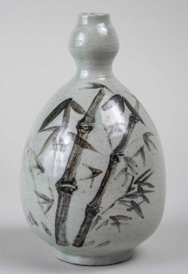 Korean Buncheong Porcelain Wine Bottle: Celadon glaze, gourd form, with bamboo and flower decoration. Height 7 1/2 inches. Notice to bidders: Due to the nature of this particular online sale, the lots offered may not be available for detail