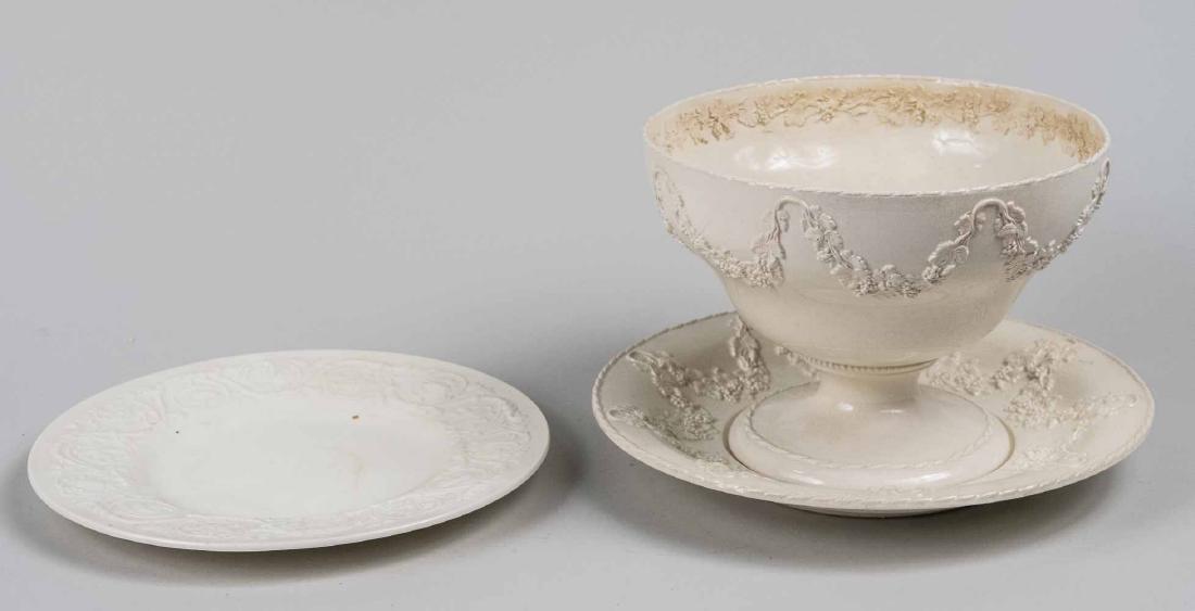 Three Creamware Dishes: 19th century, comprising a compote and two plates. Compote, height 6 inches, diameter 8 inches. Notice to bidders: Due to the nature of this particular online sale, the lots offered may not be availab