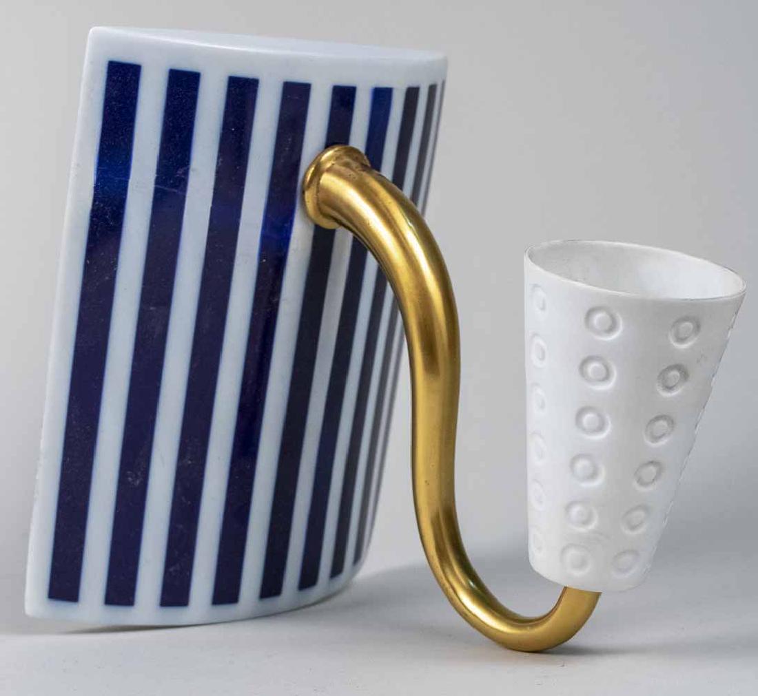 Bernardaud Porcelain Sconce: Single light sconce with porcelain shade on a gilt double scroll arm and a slightly bowed rectangular back plate with blue and white stripe decoration; together with an additional matching arm and sha