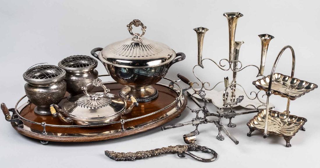 Group of Silver Plated Table Articles: Including an oval serving tray, a candelabra, dish cross, wine caddy, two tier cake stand, covered entree dish, etc. Tray, length over handles, 25 inches. Notice to bidders: Condition reports and addi