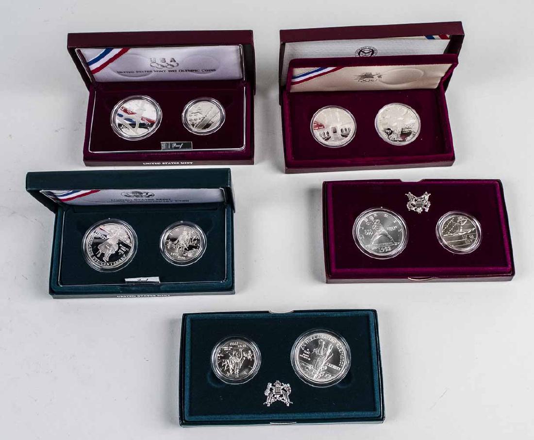 Five US Coin Sets *: (1) Los Angeles Olympic Silver Dollars, two coin proofs, 1983 and 1984 (2) 1992 US Olympic two coin uncirculated set (3)1992 US Olympic two coin proof set (4) Columbus Quincentenary Coin uncirculated