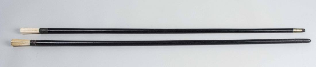 Two Bone Handled Walking Sticks: Bone handles with sterling silver collars on ebonized wood walking sticks. Taller, height 35 1/2 inches. Notice to bidders: Due to the nature of this particular online sale, the lots offered may not b