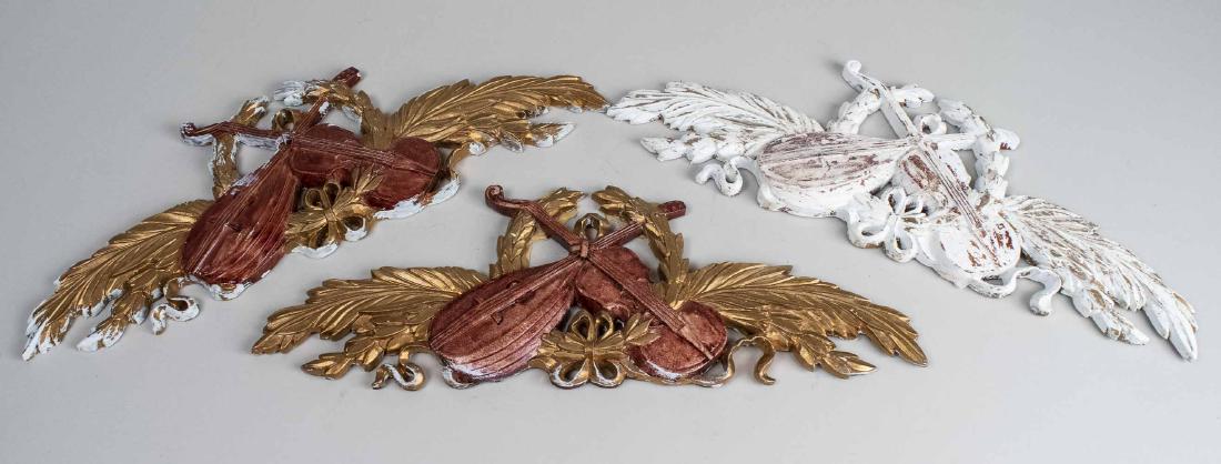Set of Three Wall Appliques: Neoclassical motifs of musical instruments and foliate decoration. 6 1/2 x 18 3/4 inches. Notice to bidders: Due to the nature of this particular online sale, the lots offered may not be available for