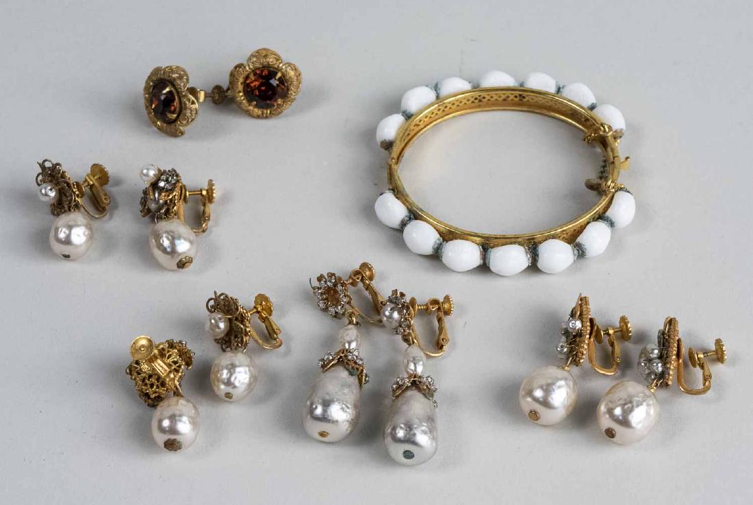 Group of Miriam Haskell Jewelry: Four pairs of simulated pearl earrings a pair of simulated topaz earrings and a white bead bangle, all signed. Notice to bidders: Condition reports and additional photographs are provided by request a