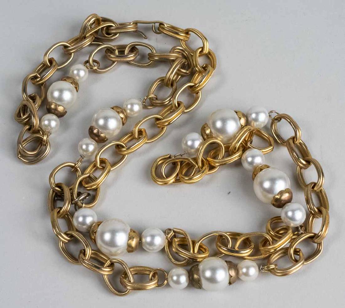 Yves St Laurent Fashion Belt: Gold tone chain belt accented with simulated pearls, signed YSL. Length 42 inches. Notice to bidders: Condition reports and additional photographs are provided by request as a courtesy to our clients,