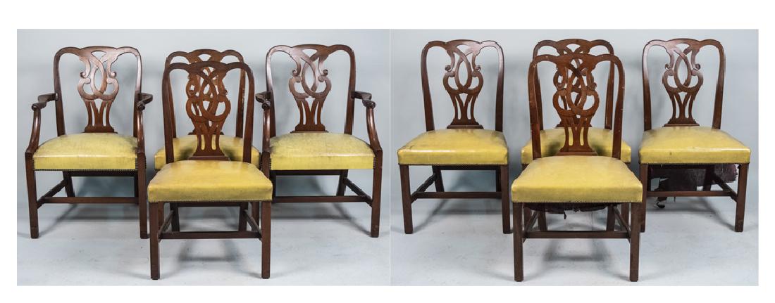 Set of Eight Dining Room Chairs: Two arm and six side chairs, each with scroll openwork splat, and faux pale yellow leather seat with nail head decoration. Height 38 inches, width 26 inches, depth 24 inches. Notice to bidders: Condit