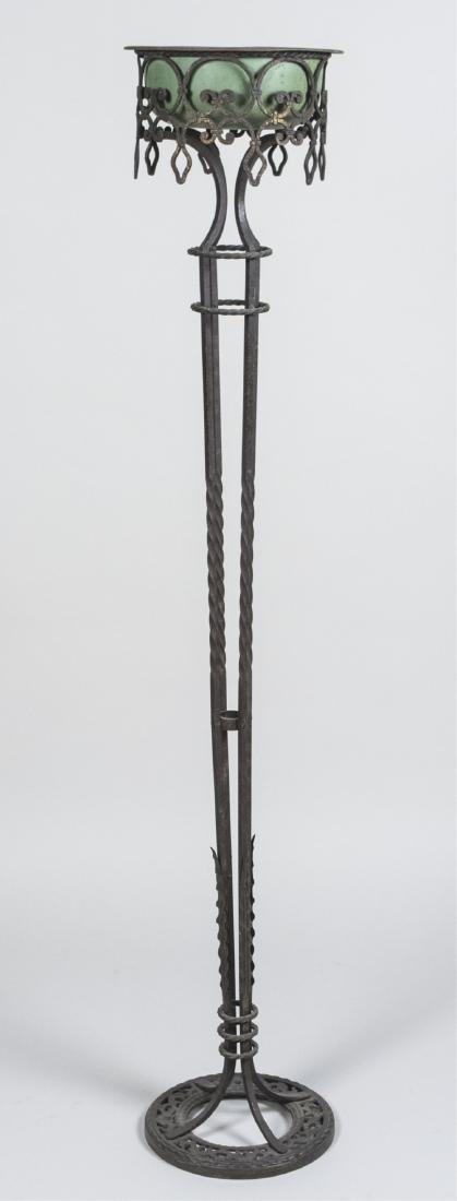 After Edgar Brandt Iron Plant Stand: Green metal bowl resting in a wrought iron stand. Height 60 inches. Notice to bidders: Condition reports and additional photographs are provided by request as a courtesy to our clients, as such any co