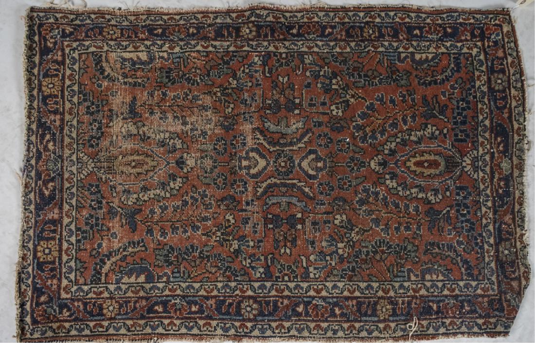 Persian Lilihan Carpet: Allover stylized floral and palmette decoration on a rust colored field, within an ivory and navy blue border with similiarly styled flowering vine decoration. 3 feet 10 inches x 2 feet 6 inches. Noti