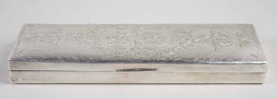 Silvered Metal Box: Rectangular with engraved floral decoration. Length 9 inches. Notice to bidders: Condition reports and additional photographs are provided by request as a courtesy to our clients, as such any conditio