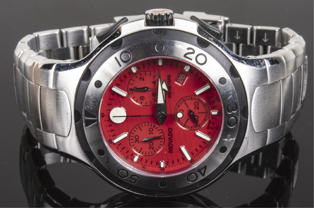 Movado Wristwatch: #84 C5 1896 and 9132201, red dial with baton hours, sweep seconds hand, three subsidiary dials and date aperture, stainless steel band. Notice to bidders: Condition reports and additional photographs