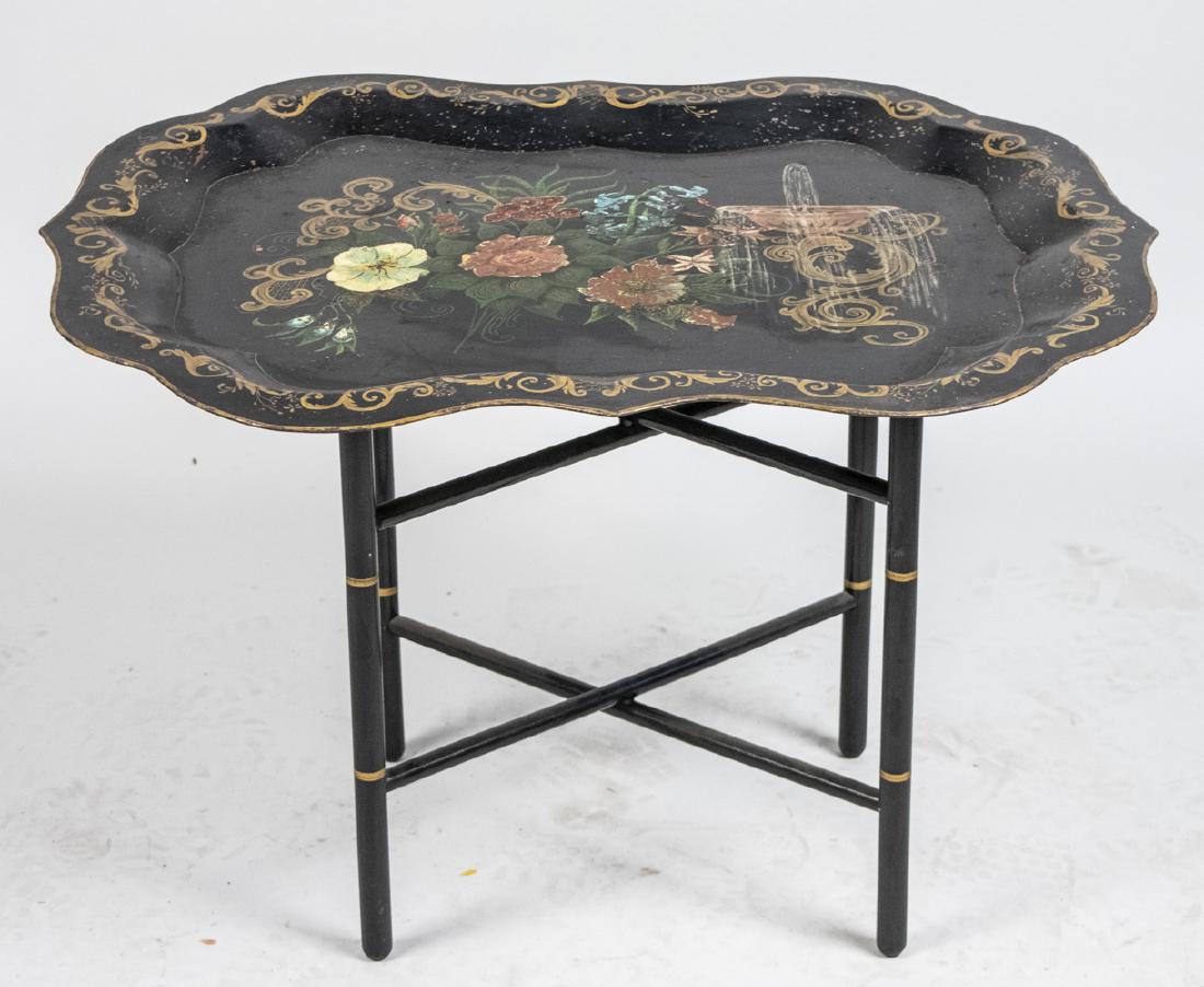 Tole Tray Top Table: Shaped rectangular tray with floral decoration on a faux bamboo painted stand. Height 19 inches, width 29 inches, depth 23 inches. Notice to bidders: Condition reports and additional photographs are p