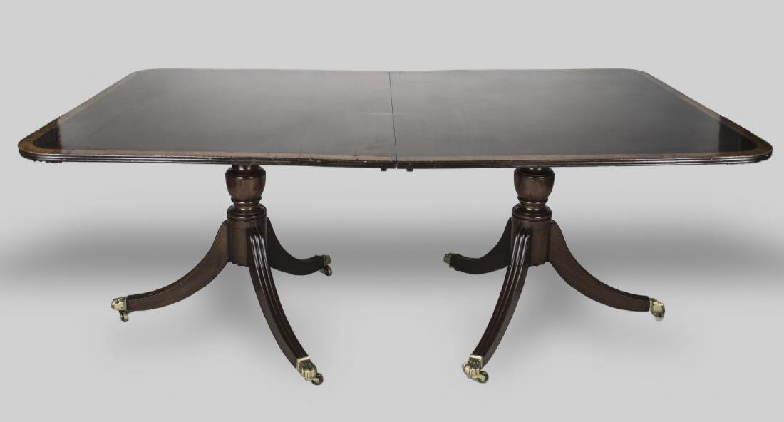Regency Style Mahogany Dining Table: Rectangular top with crossbanded edge on two pedestals with reeded legs ending in brass casters. Height 29 inches, length 6 feet, width 45 inches, leaves width 2 feet Notice to bidders: Condition repo
