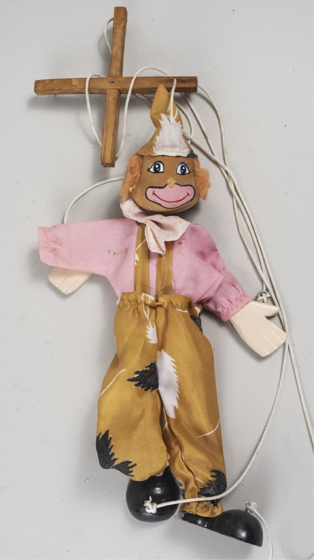 Clown Puppet: With polychrome painted head, hands and feet (missing one hand) and fabric costume. Height 16 inches. Notice to bidders: Condition reports and additional photographs are provided by request as a court