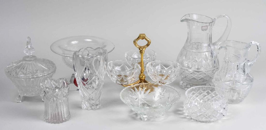 Group of Colorless Glass Table Decorations: Including a pitcher, fan form tray, Orrefors bowl, basket, etc. Tallest, height 9 1/2 inches. Notice to bidders: Condition reports and additional photographs are provided by request as a courtesy to o