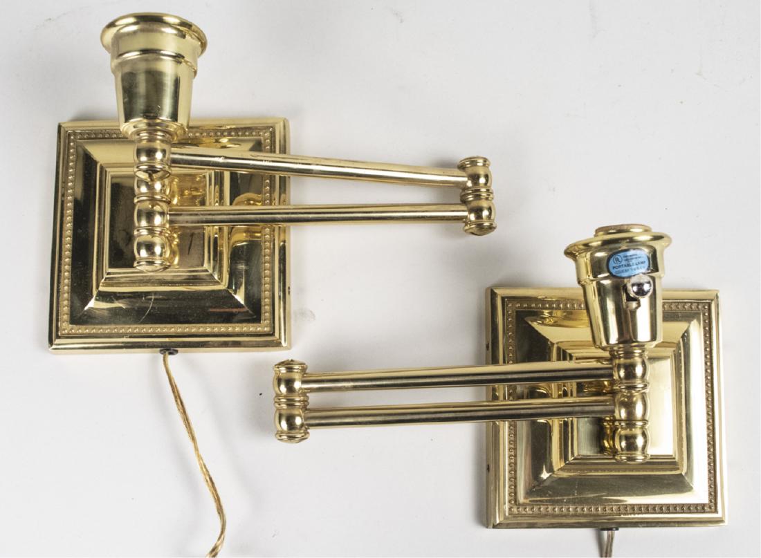 Pair of Brass Swing Arm Sconces: Adjustable arms. Height 7 1/4 inches. Notice to bidders: Condition reports and additional photographs are provided by request as a courtesy to our clients, as such any condition report is only an opin