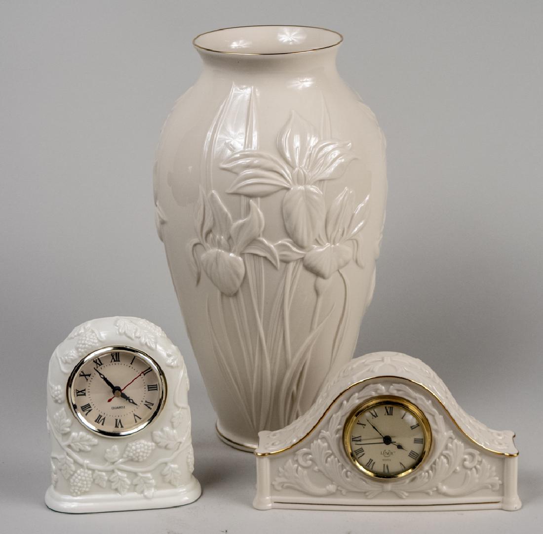 Lenox Porcelain Table Decorations: Ovoid vase and two desk clocks. Tallest, height 15 inches. Notice to bidders: Condition reports and additional photographs are provided by request as a courtesy to our clients, as such any condition r