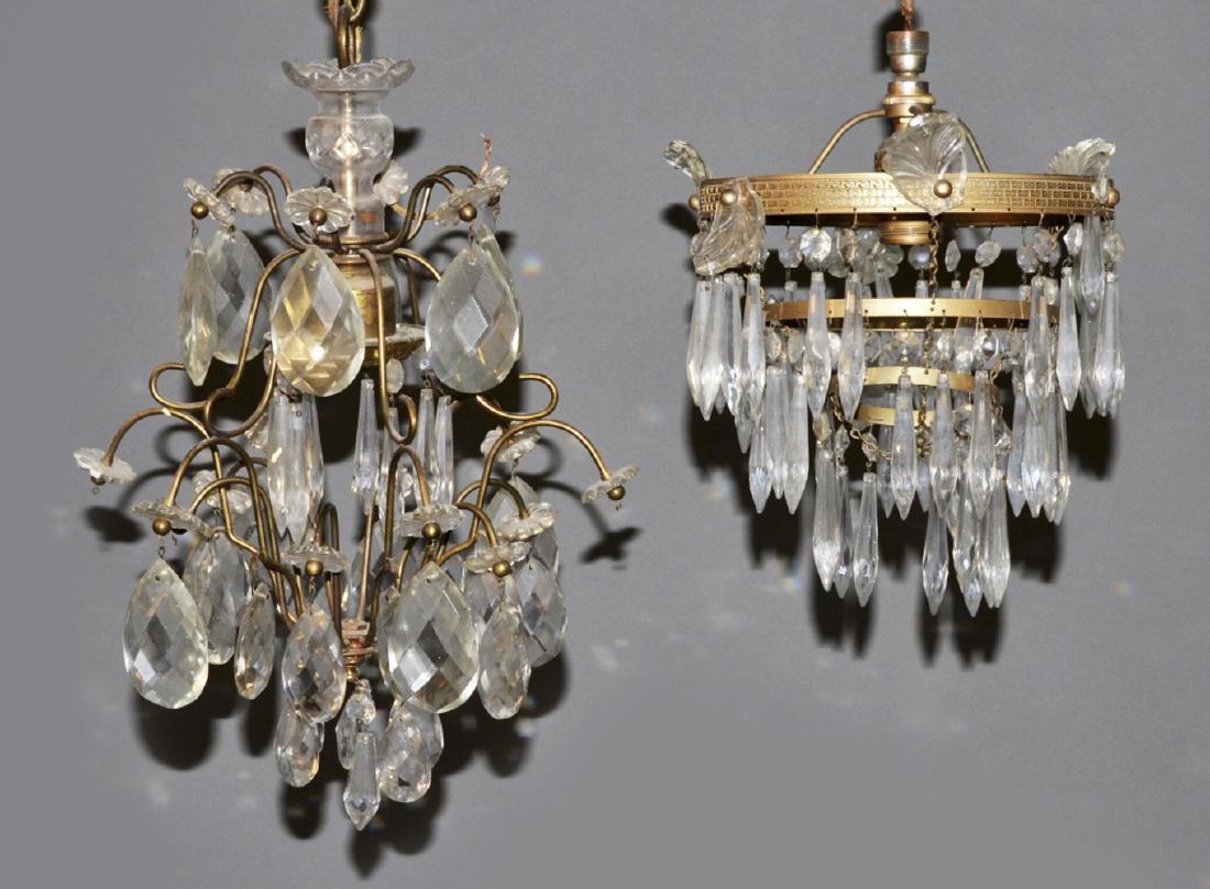 Two Brass and Crystal Fixtures: One a cage form single light fixture with crystal drop and flower decoration,the other a three tier single light ring form chandelier with crystal prism and palmette decoration. Larger, height 16 inch