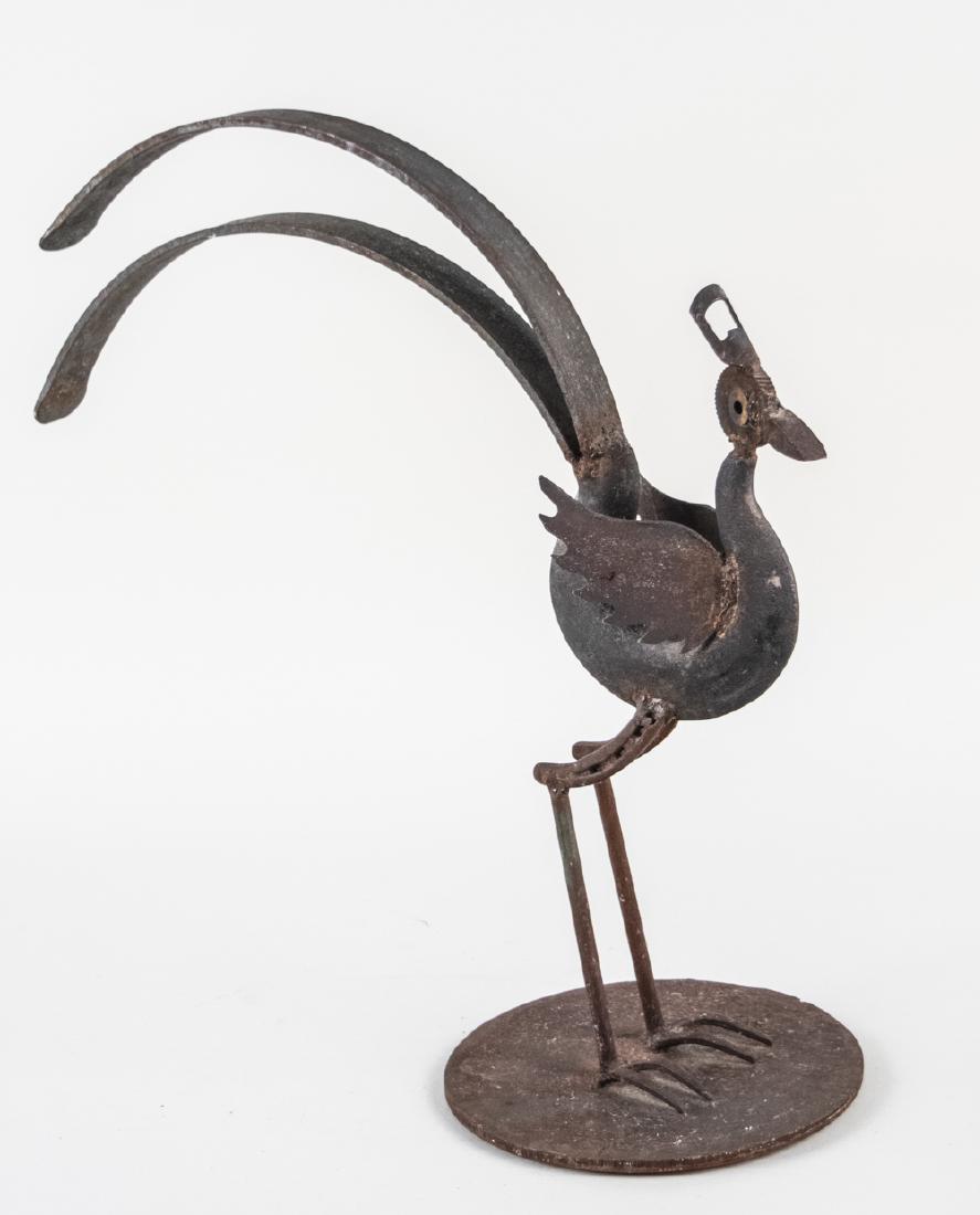 Bill Heise Sculpture (American, 20th Century): Found metal formed as a plumed bird. Signed Heise on the base. Oveall height, 23 inches. Base, 10 inches in diameter. Notice to bidders: Condition reports and additional photographs are provided by re