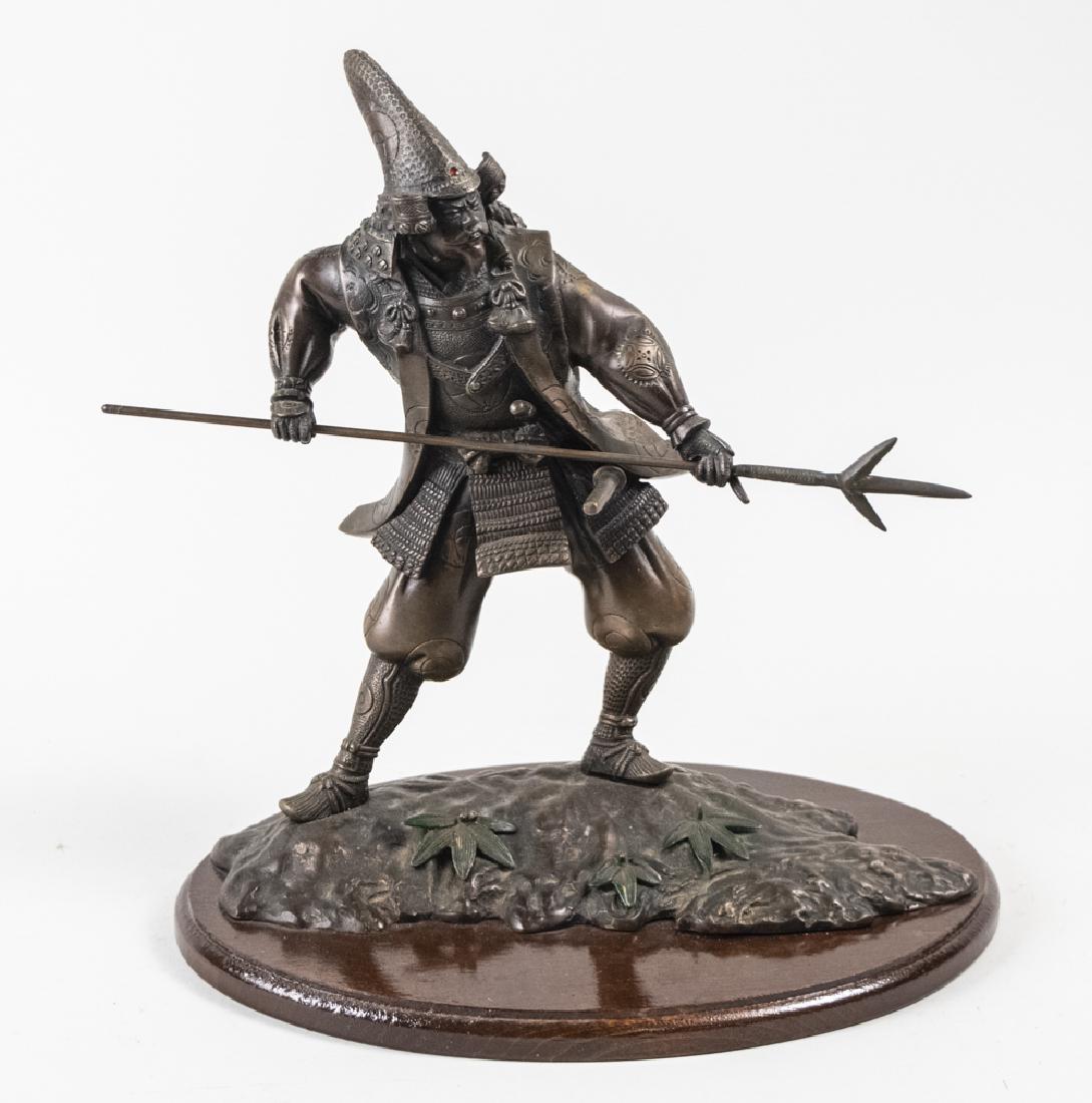 Japnese Meiji Style Bronze Figure of Kato Kiyonasa: Modeled wielding a spear, with applied ruby decoration, signed on right knee, on wood base. Height 14 inches. Notice to bidders: Due to the nature of this particular online sale, the lots offered may 
