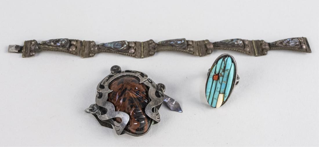 Three Mexican Silver Jewelry Articles: Bracelet with abalone, a pin / pendant and a turquoise ring. Notice to bidders: Condition reports and additional photographs are provided by request as a courtesy to our clients, as such any condition