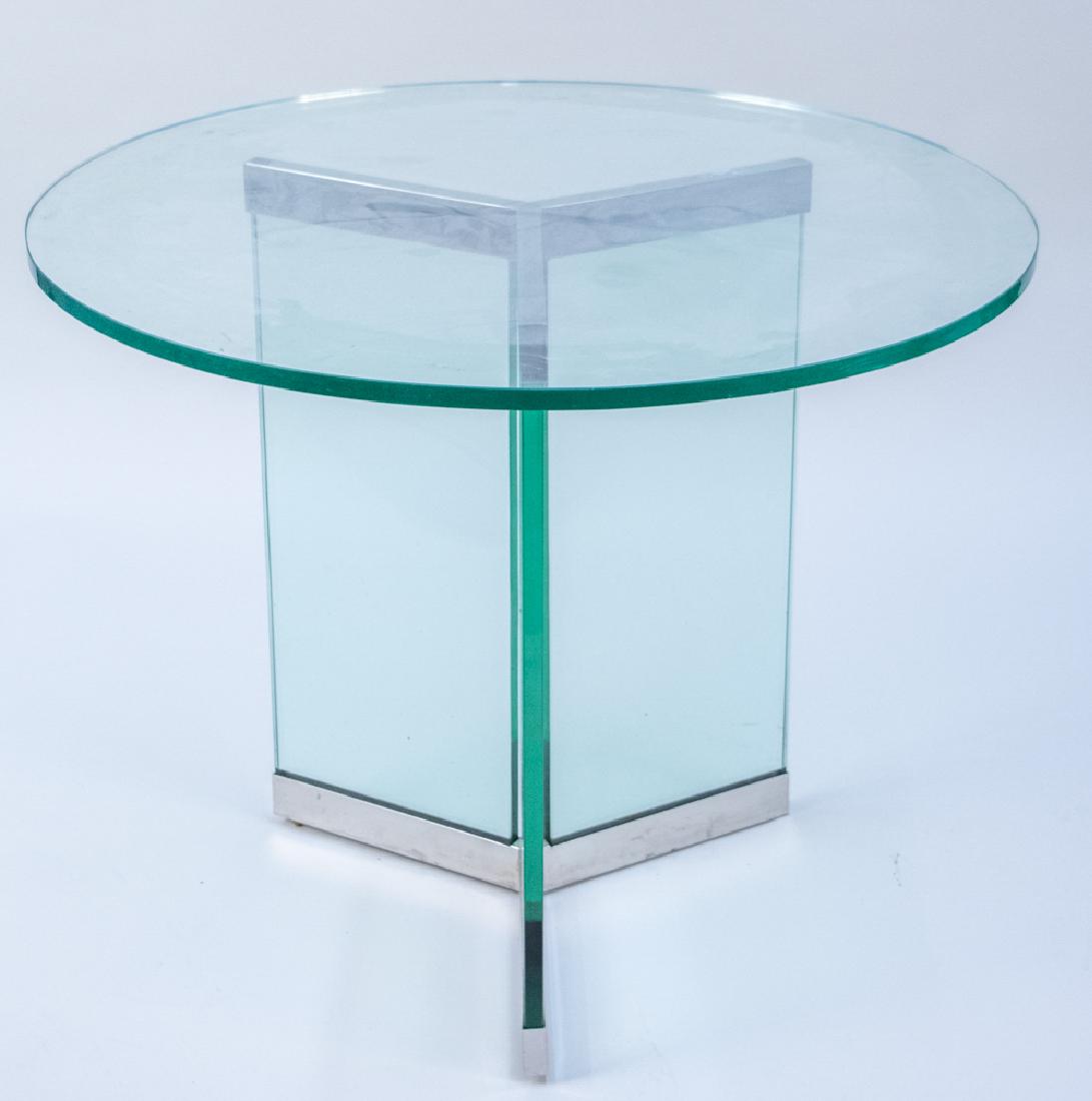 Glass Top Table: Circular top on a tri part base with chrome accents. Height 29 inches, diameter 36 inches. Notice to bidders: Condition reports and additional photographs are provided by request as a courtesy to our