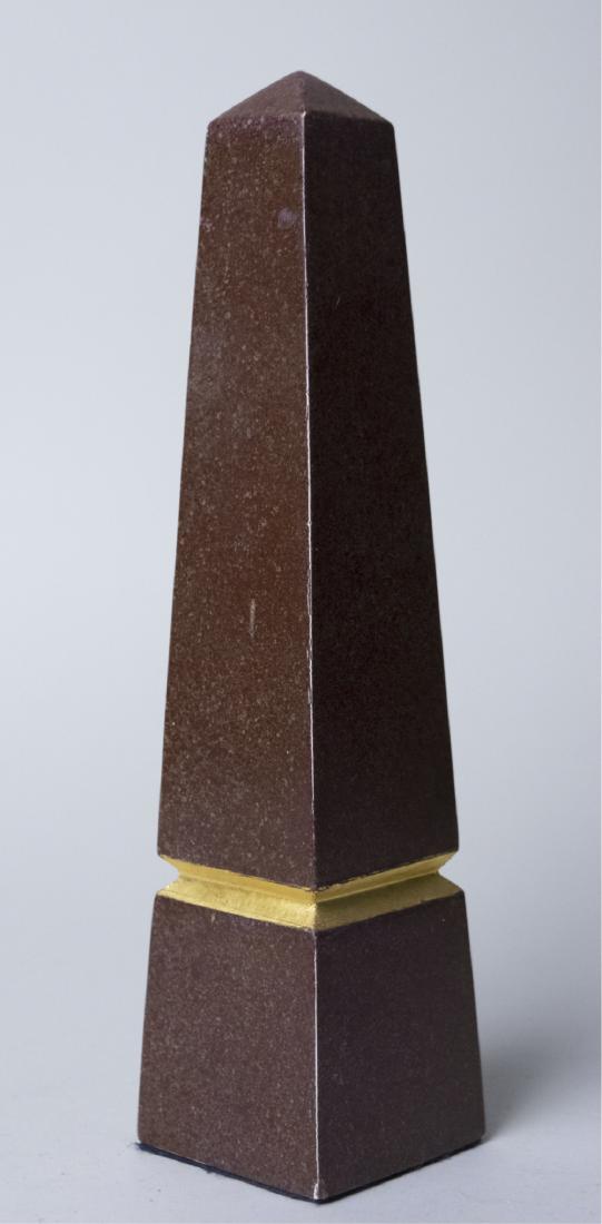 Wood Obelisk: Gold painted trim. Height 11 1/2 inches. Notice to bidders: Condition reports and additional photographs are provided by request as a courtesy to our clients, as such any condition report is only an o