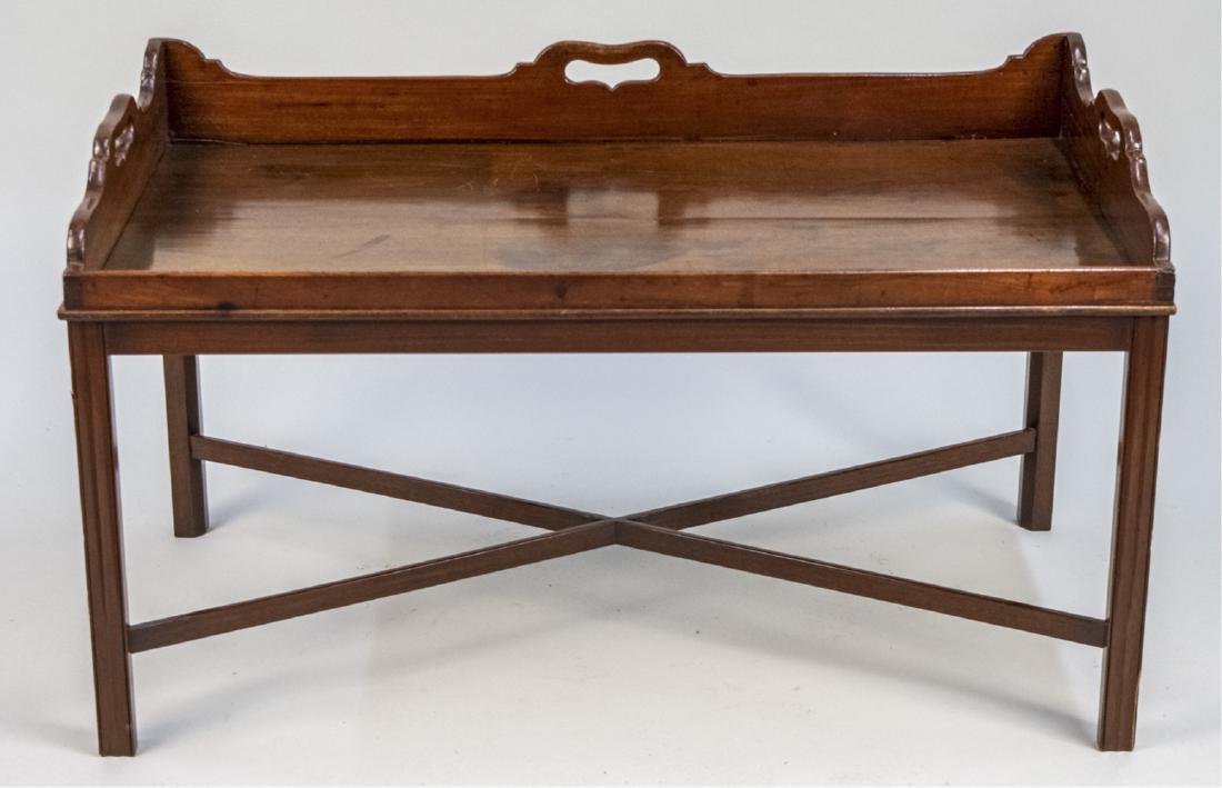 Mahogany Butlers Tray Coffee Table: Rectangular two handle tray on block legs joined by an X stretcher. Notice to bidders: Condition reports and additional photographs are provided by request as a courtesy to our clients, as such any co