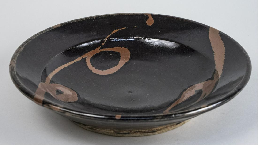 Shoji Hamada (Japanese) Pottery Dish: Shallow dish. (No box) Diameter 12 inches. Notice to bidders: Condition reports and additional photographs are provided by request as a courtesy to our clients, as such any condition report is only an