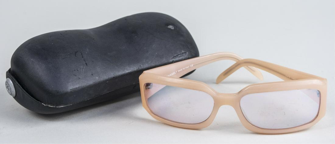 Chanel Sunglasses: Peach coloured frames with mirrored lenses, in original Chanel case, retailed by Bloomingdales. Notice to bidders: Due to the nature of this particular online sale, the lots offered may not be availab
