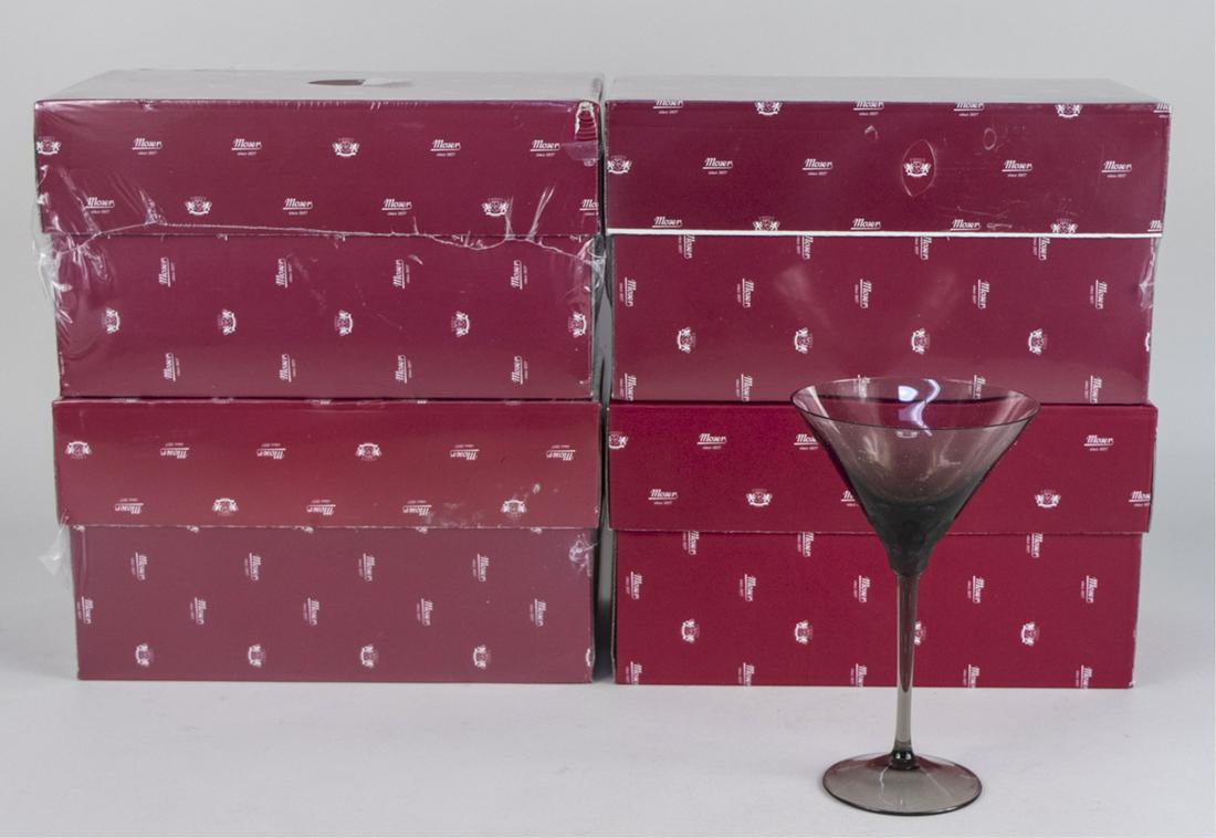 Group of Four Moser Pebble Martini Glasses: Including three clear and one smoke martini glass, in original boxes. Notice to bidders: Due to the nature of this particular online sale, the lots offered may not be available for detailed condition 