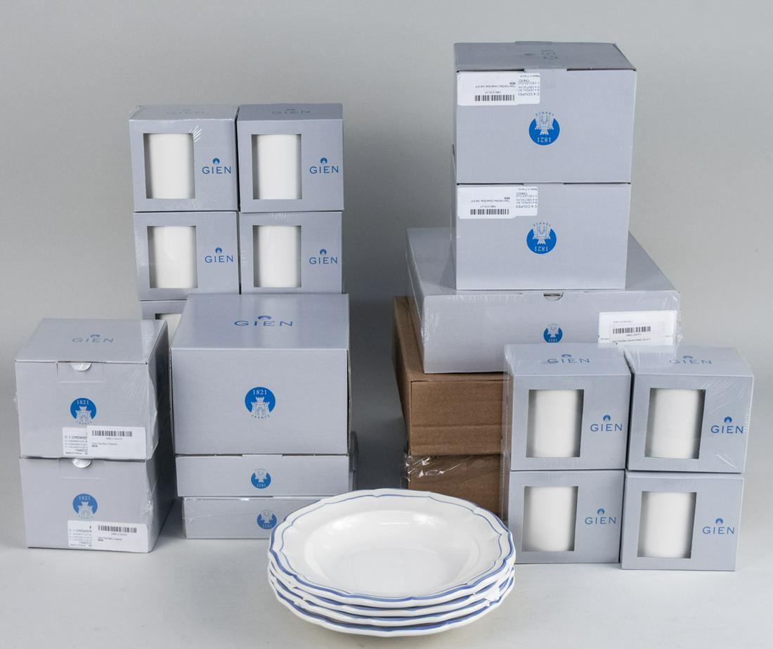 Gien Filet Bleu Partial Dinner Service: Fifty pieces, comprising eight dinner plates, four dessert plates, four rim soup bowls, two creamers, eight canape plates, twelve cereal bowls and twelve mugs. Dinner plate diameter 10 5/8 inches. Not