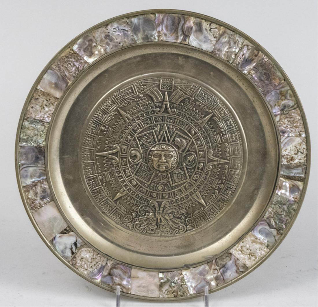 Mexican Aztec Calendar Plate: Circular with abalone border. Diameter 11 inches. Notice to bidders: Due to the nature of this particular online sale, the lots offered may not be available for detailed condition reports or additiona